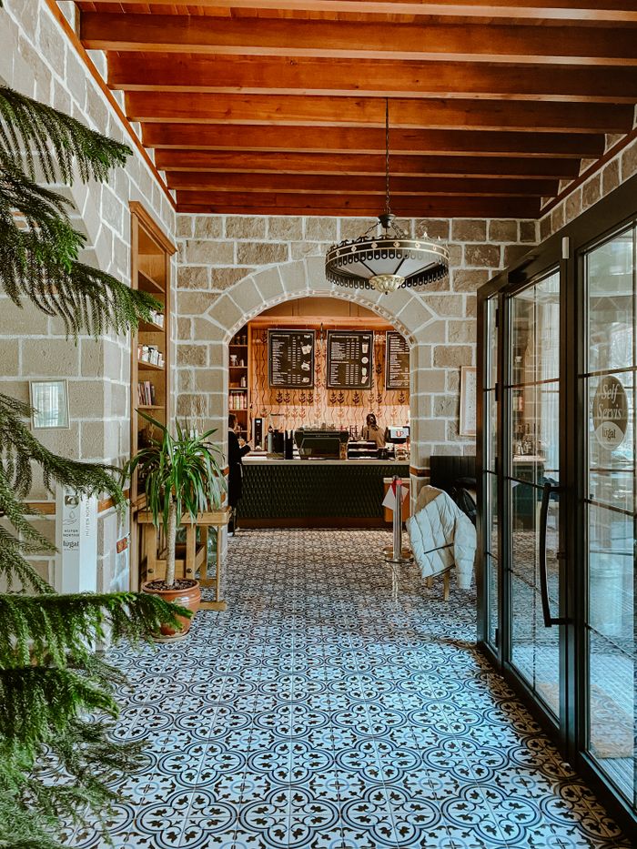 A cozy cafe entrance featuring rustic design elements and inviting decor.